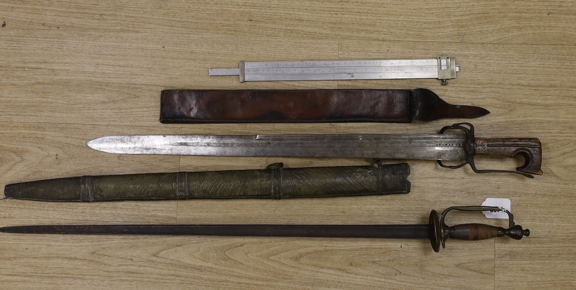 A Moroccan nimcha sword with associated Andrea Ferrara (Scottish) blade and a scabbard together with a court sword and an Aston & Mander Ltd. Mk VI military rule in leather case